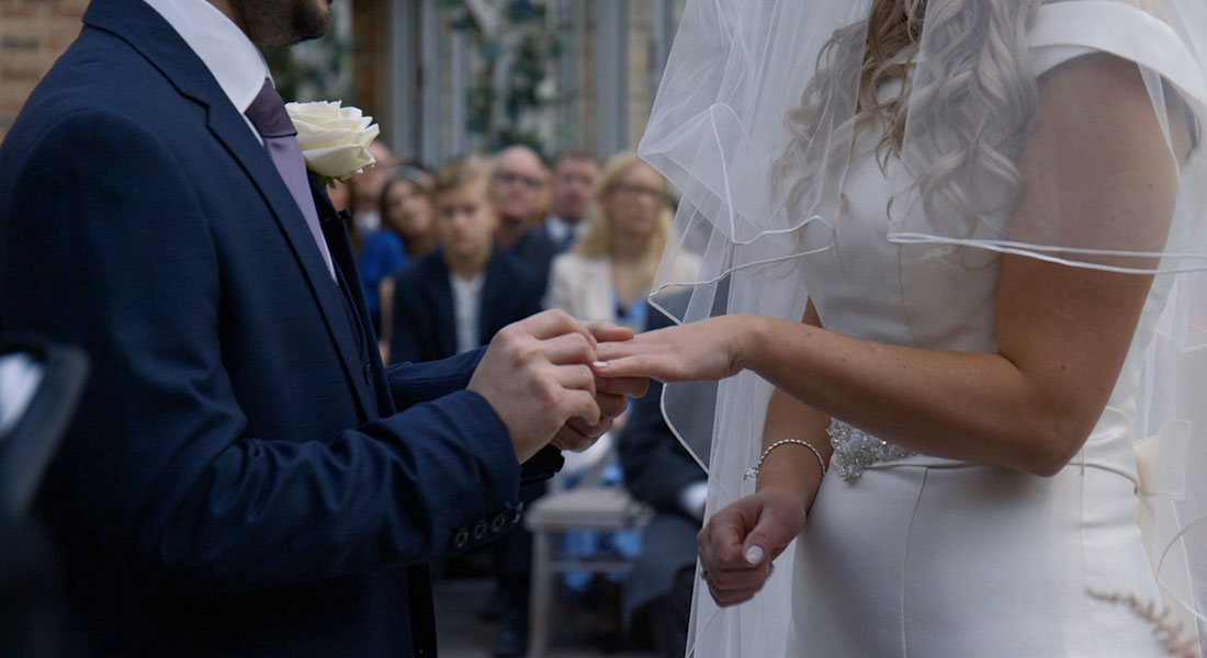 Ed slides the ring on Hanna's finger on their wedding day 